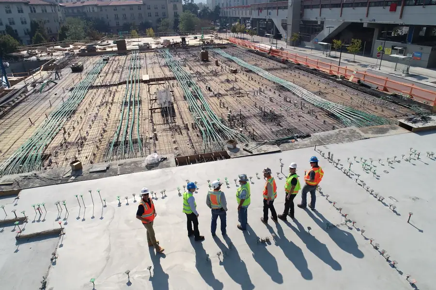 Aerial view of an active construction site with crews at work