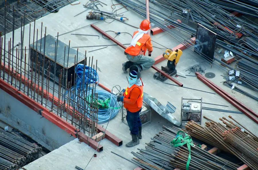 Construction workers placing rebar on an active project site